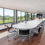 Large Commercial meeting room with an oval table.