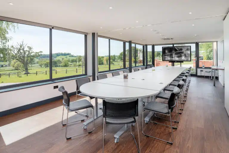 Large Commercial meeting room with an oval table.