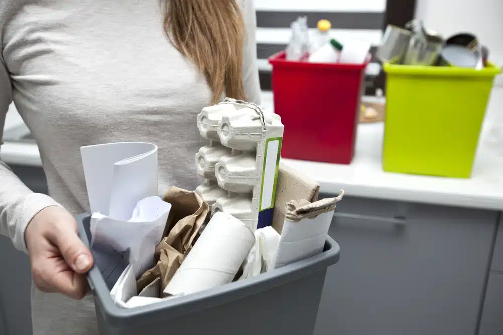 woman carrying box of office paper waste